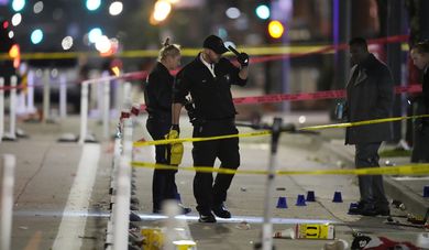Denver Police Department investigators work the scene of a mass shooting along Market Street between 20th and 21st avenues during a celebration after the Denver Nuggets won the team's first NBA Championship early Tuesday, June 13, 2023, in Denver. (AP Photo/David Zalubowski)