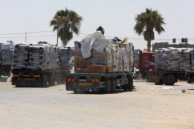 Trucks loaded with goods enter the Gaza Strip from Israel through the Kerem Shalom crossing in Rafah in the southern Gaza Strip on July 14, 2021. The director of Karem Abu Salem border crossing Bassam Ghaben said that the Israeli authorities reversed a recent decision, which banned the entry of goods into the Gaza strip. The occupation state allowed the entry of all goods, except for construction materials. (Photo by Majdi Fathi/NurPhoto via Getty Images)